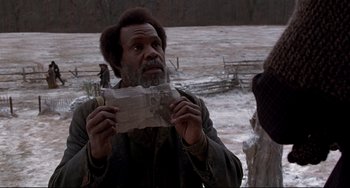 Movie still from “Beloved” (1998), directed by Jonathan Demme – A man holding a piece of paper in his hands; Close Up shot, Over the shoulder angle