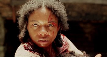 Movie still from “Beloved” (1998), directed by Jonathan Demme – A woman with blood all over her face and neck; Close Up shot, Low angle