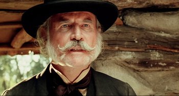 Movie still from “Beloved” (1998), directed by Jonathan Demme – An old man with a mustache wearing a hat; Close Up shot, Low angle