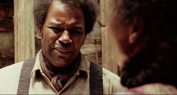 Movie still from “Beloved” (1998), directed by Jonathan Demme – A man with a beard and a tie is looking at another man with a beard; Close Up shot, Over the shoulder angle