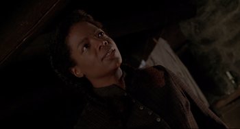 Movie still from “Beloved” (1998), directed by Jonathan Demme – A woman looking up at the ceiling in a dark room; Close Up shot, Low angle