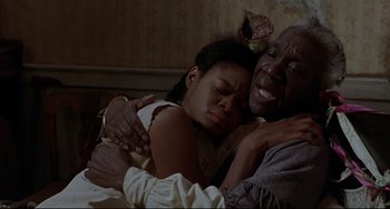 Movie still from “Beloved” (1998), directed by Jonathan Demme – A man and a woman are hugging in a bed; Close Up shot, Low angle