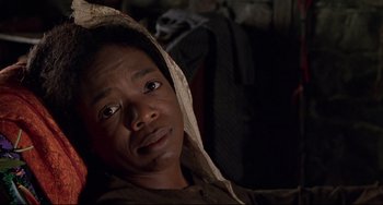 Movie still from “Beloved” (1998), directed by Jonathan Demme – A person with a hood over their head; Close Up shot, Low angle