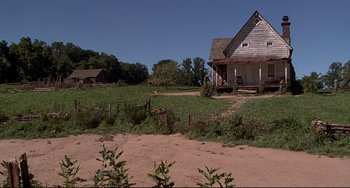 Movie still from “Beloved” (1998), directed by Jonathan Demme – An old farm house in the middle of a fenced in field; Extreme Wide shot, High angle