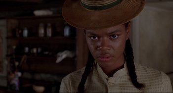 Movie still from “Beloved” (1998), directed by Jonathan Demme – A person wearing a hat and a shirt; Close Up shot, Low angle