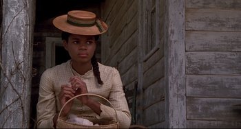 Movie still from “Beloved” (1998), directed by Jonathan Demme – A woman in a hat holding a wicker basket; Close Up shot, Low angle