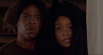 Movie still from “Beloved” (1998), directed by Jonathan Demme – A man and a woman standing next to each other in the dark; Close Up shot, Low angle