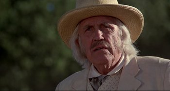 Movie still from “Beloved” (1998), directed by Jonathan Demme – An old man with a white beard wearing a straw hat; Close Up shot, Low angle