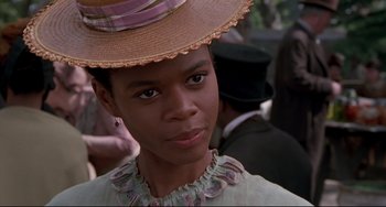 Movie still from “Beloved” (1998), directed by Jonathan Demme – A woman wearing a straw hat and a dress; Close Up shot, Over the shoulder angle