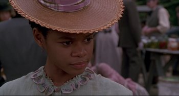 Movie still from “Beloved” (1998), directed by Jonathan Demme – A young girl wearing a hat and a dress; Close Up shot, Low angle