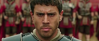 Movie still from “Ben-Hur” (2016), directed by Timur Bekmambetov – Close up of a man's face in a military uniform; Close Up shot, Low angle