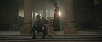 Movie still from “Ben-Hur” (2016), directed by Timur Bekmambetov – A man and a woman sitting on steps next to each other; Wide shot, Low angle