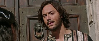 Movie still from “Ben-Hur” (2016), directed by Timur Bekmambetov – A person with long brown hair; Close Up shot, Over the shoulder angle