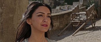 Movie still from “Ben-Hur” (2016), directed by Timur Bekmambetov – A woman's face in front of a stone wall; Close Up shot, Over the shoulder angle