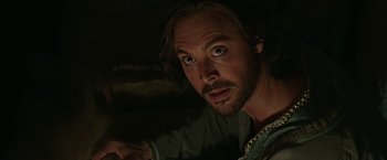 Movie still from “Ben-Hur” (2016), directed by Timur Bekmambetov – A person with a beard looking at the camera; Close Up shot, Low angle