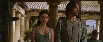 Movie still from “Ben-Hur” (2016), directed by Timur Bekmambetov – A woman in a dress standing next to a man in a dress; Medium shot, Over the shoulder angle