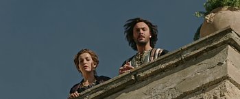 Movie still from “Ben-Hur” (2016), directed by Timur Bekmambetov – A man and a woman standing next to each other on a ledge; Medium shot, Low angle