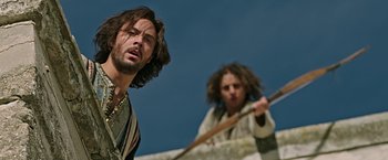 Movie still from “Ben-Hur” (2016), directed by Timur Bekmambetov – A man and a woman are standing in a field; Medium shot, Low angle