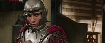 Movie still from “Ben-Hur” (2016), directed by Timur Bekmambetov – A man wearing a helmet and a metal armor; Close Up shot, Over the shoulder angle