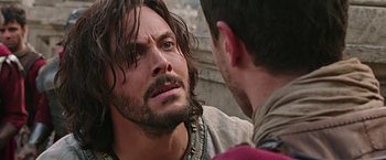 Movie still from “Ben-Hur” (2016), directed by Timur Bekmambetov – A man with long hair and a beard talking to another man with long hair; Close Up shot, Over the shoulder angle