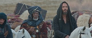 Movie still from “Ben-Hur” (2016), directed by Timur Bekmambetov – A man and a woman standing next to each other in the snow; Medium shot, Low angle