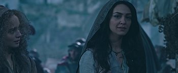 Movie still from “Ben-Hur” (2016), directed by Timur Bekmambetov – A woman with long dark hair wearing a hood; Close Up shot, Over the shoulder angle