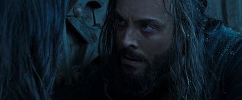 Movie still from “Ben-Hur” (2016), directed by Timur Bekmambetov – A man with long hair and a beard stares at the camera; Close Up shot, High angle
