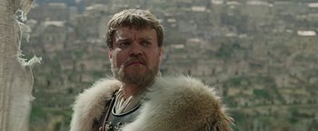 Movie still from “Ben-Hur” (2016), directed by Timur Bekmambetov – A person with a beard wearing a fur coat; Close Up shot, Low angle