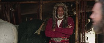 Movie still from “Ben-Hur” (2016), directed by Timur Bekmambetov – An older man with dreadlocks standing with his arms crossed; Close Up shot, Low angle