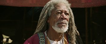 Movie still from “Ben-Hur” (2016), directed by Timur Bekmambetov – An older man with dreads is looking at the camera; Close Up shot, Low angle