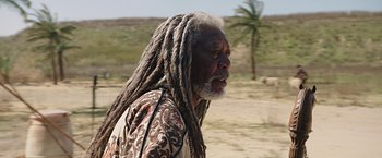 Movie still from “Ben-Hur” (2016), directed by Timur Bekmambetov – An older man with dreads standing on a dirt road; Close Up shot, Over the shoulder angle