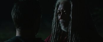 Movie still from “Ben-Hur” (2016), directed by Timur Bekmambetov – An older man with dreads is looking into the camera; Close Up shot, Over the shoulder angle