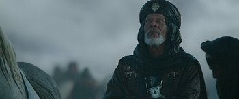 Movie still from “Ben-Hur” (2016), directed by Timur Bekmambetov – An older man wearing a turban and a black jacket; Medium shot, Low angle