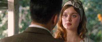 A young woman looking at a man in a suit