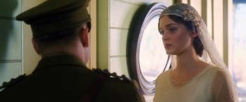 A man and a woman standing next to each other in front of a window
