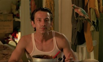 Movie still from “Betty Blue” (1986), directed by Jean-Jacques Beineix – A man sitting in front of a bowl of food; Close Up shot, Low angle