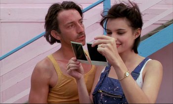 Movie still from “Betty Blue” (1986), directed by Jean-Jacques Beineix – A man and a woman taking a picture of themselves; Close Up shot, Low angle