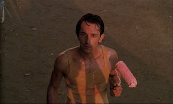 Movie still from “Betty Blue” (1986), directed by Jean-Jacques Beineix – A man holding a paint roller in his hand; Close Up shot, Low angle