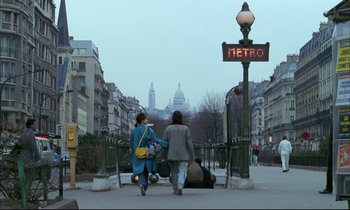Movie still from “Betty Blue” (1986), directed by Jean-Jacques Beineix – Two women are walking down the sidewalk of a city street; Wide shot, Low angle