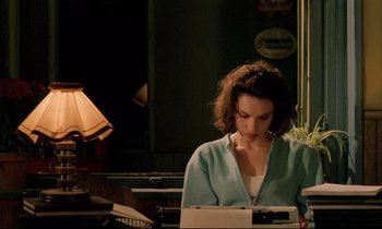 Movie still from “Betty Blue” (1986), directed by Jean-Jacques Beineix – A woman sitting in front of a laptop computer; Medium shot, High angle