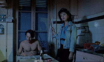 Movie still from “Betty Blue” (1986), directed by Jean-Jacques Beineix – A man and a woman in a kitchen; Medium shot, Low angle