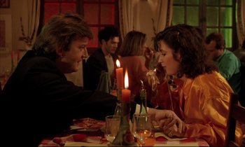 Movie still from “Betty Blue” (1986), directed by Jean-Jacques Beineix – A man and a woman sitting at a dinner table; Medium shot, Over the shoulder angle