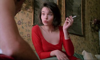 Movie still from “Betty Blue” (1986), directed by Jean-Jacques Beineix – A woman in a red dress smoking a cigarette; Close Up shot, Over the shoulder angle
