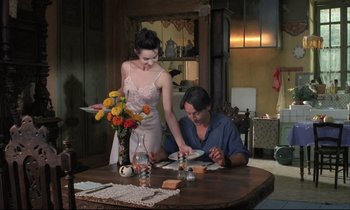Movie still from “Betty Blue” (1986), directed by Jean-Jacques Beineix – A man and a woman sitting at a dining room table; Medium shot, Low angle