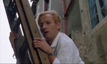 Movie still from “Betty Blue” (1986), directed by Jean-Jacques Beineix – A man leaning on a wooden plank in a building; Close Up shot, Low angle