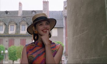 Movie still from “Betty Blue” (1986), directed by Jean-Jacques Beineix – A woman wearing a hat standing next to a building; Close Up shot, Low angle