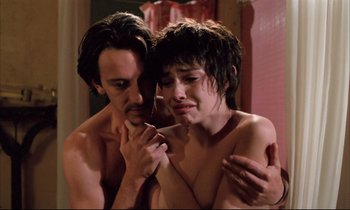 Movie still from “Betty Blue” (1986), directed by Jean-Jacques Beineix – A man and a woman in a room with their arms around one another; Close Up shot, Low angle