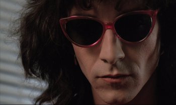 Movie still from “Betty Blue” (1986), directed by Jean-Jacques Beineix – A person wearing a pair of sunglasses; Extreme Close Up shot, Low angle