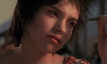 Movie still from “Betty Blue” (1986), directed by Jean-Jacques Beineix – A person with short black hair; Close Up shot, Low angle