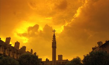 Movie still from “Betty Blue” (1986), directed by Jean-Jacques Beineix – A cross on top of a building under a cloudy sky; Extreme Wide shot, Low angle
